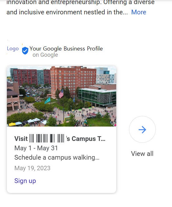 Aerial view of a campus courtyard with people, flags, and surrounding buildings on a sunny day.