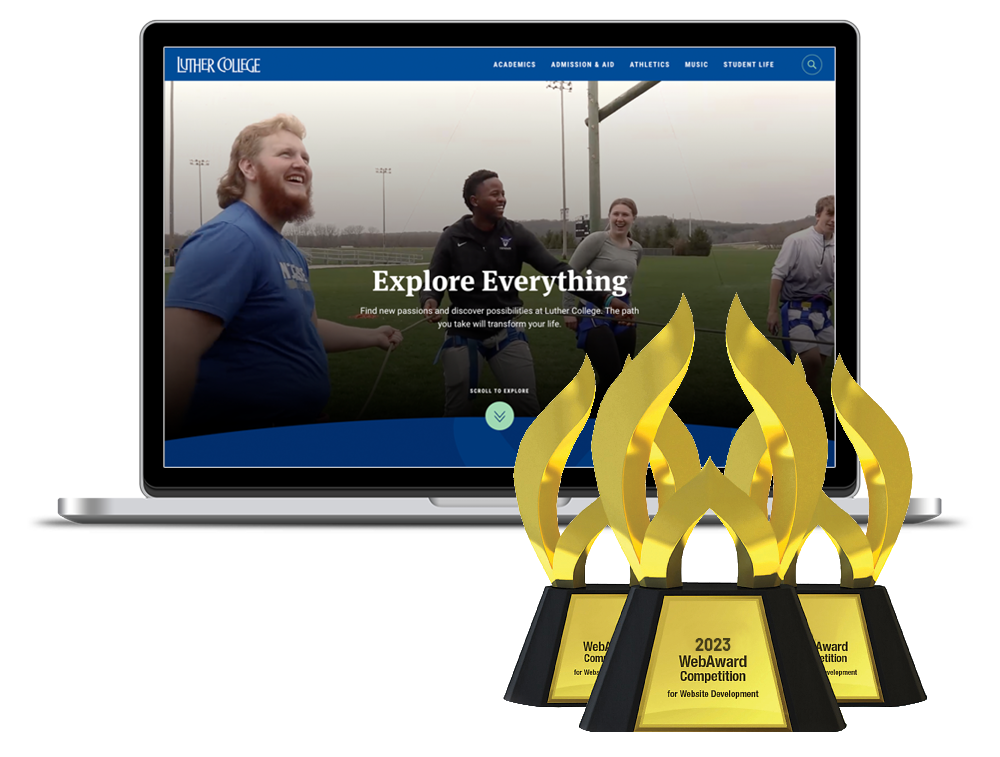 A laptop displaying a college website, with four gold WebAward trophies in front of it.