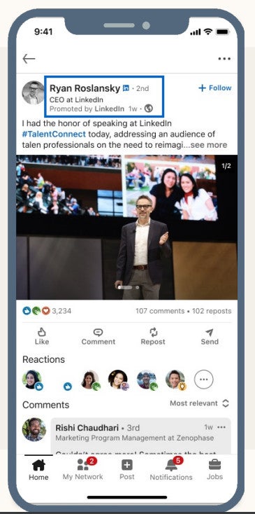 A LinkedIn post on a smartphone shows a man speaking on stage at a professional event.