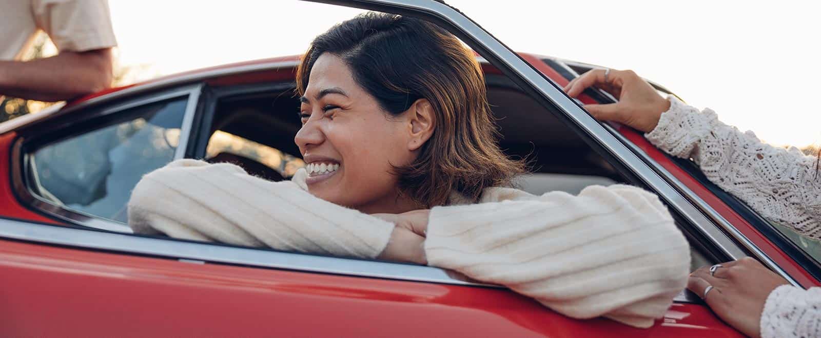 Woman leaning out of car window