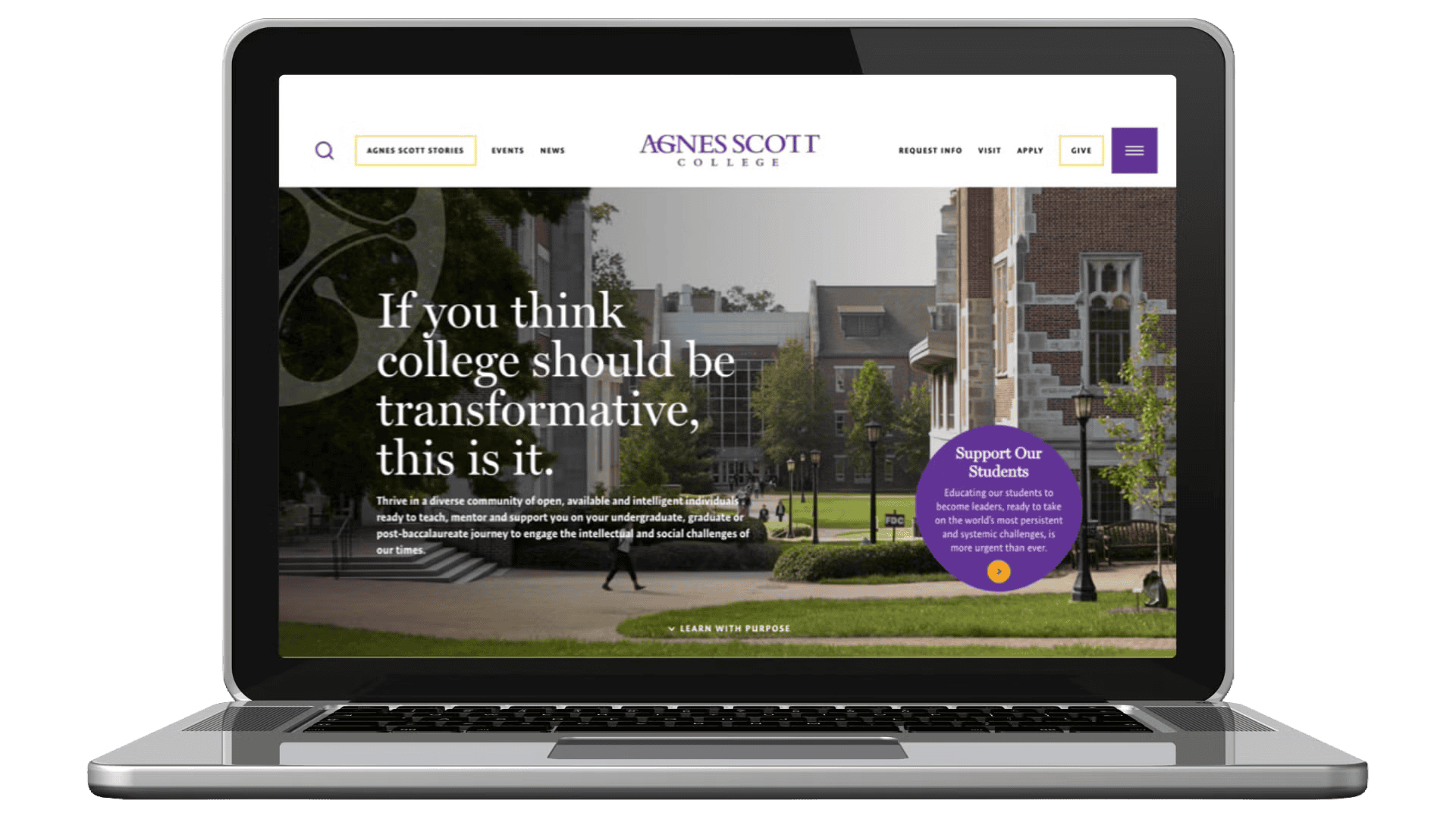 Laptop displaying Agnes Scott College website homepage with campus buildings and text about transformative college.