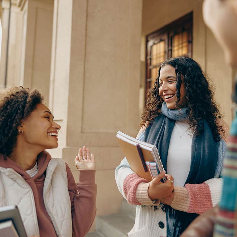 Students talking outside of building