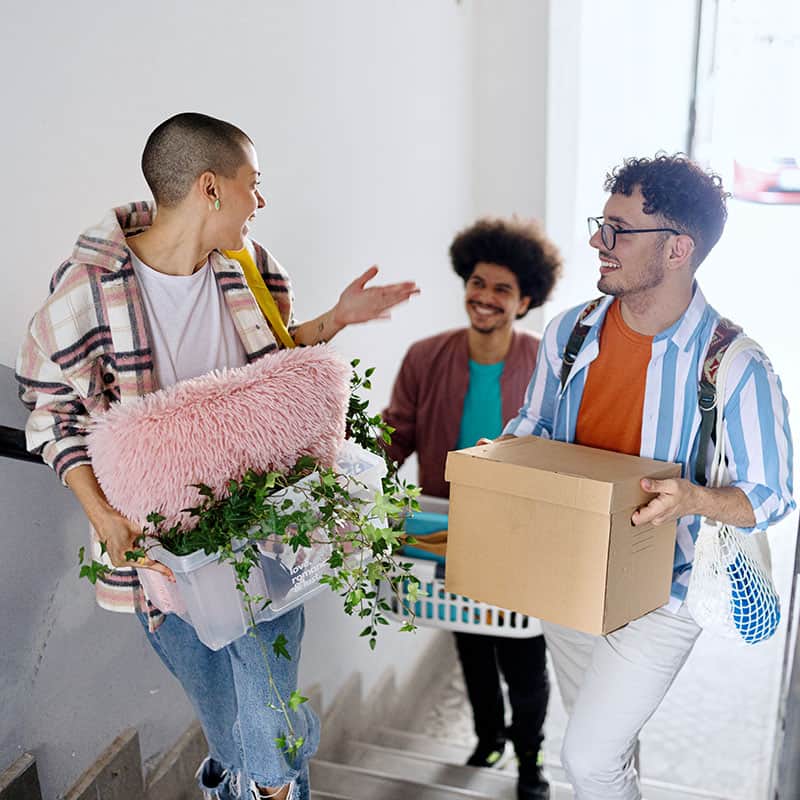 Three students moving into a new place