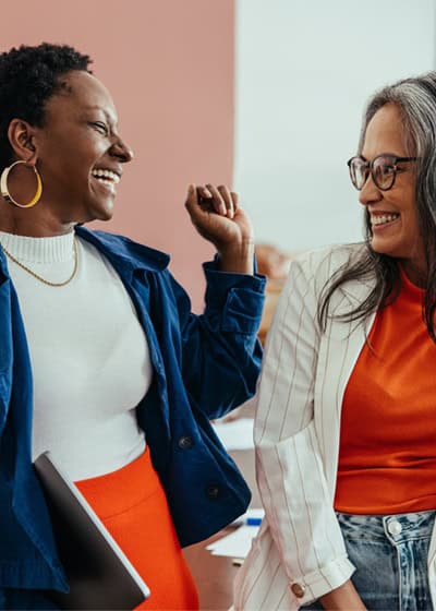 Two women smiling and chatting.