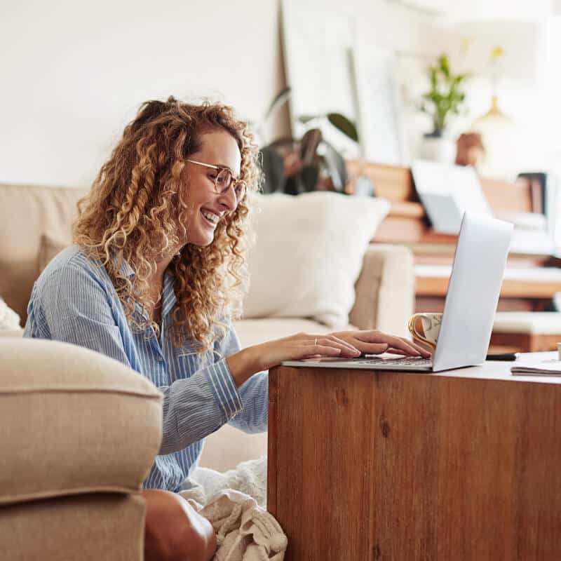 Woman indoors with laptop.