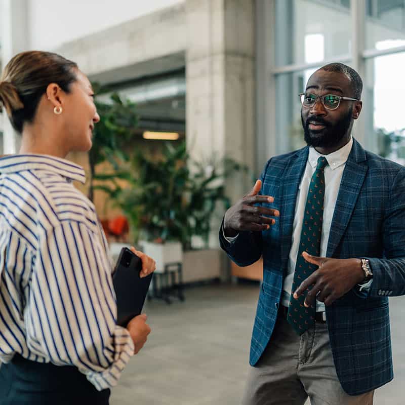 Woman and man talking in building lobby