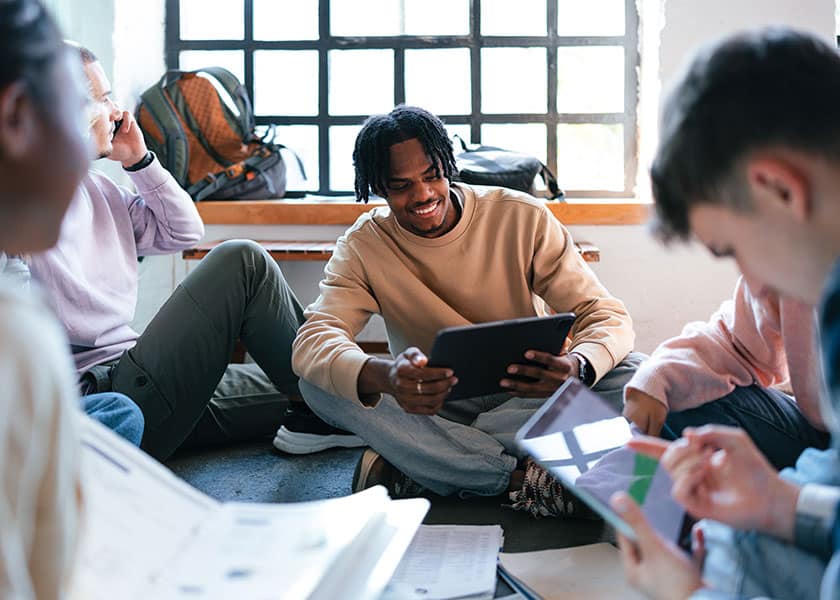 Male students in room with tablets