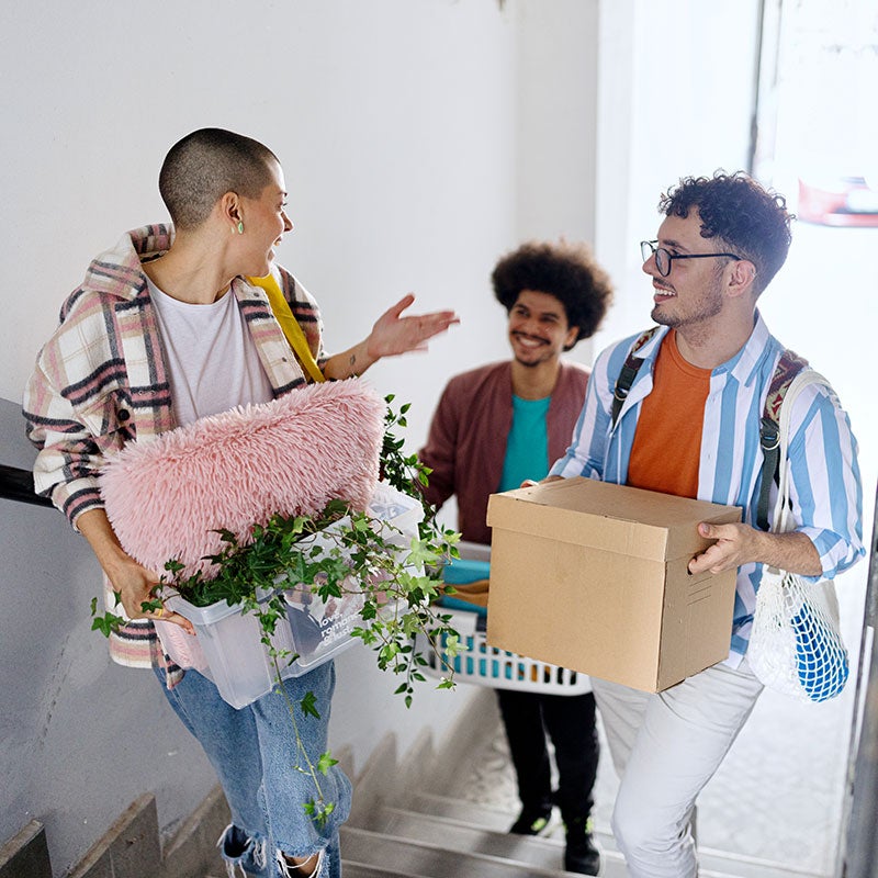 Three students moving into a new place