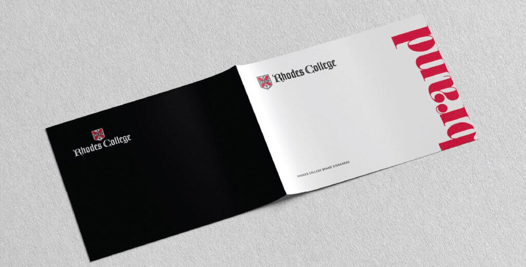An open booklet with "Rhodes College" logo on black and white pages, with "brand" in bold red text.